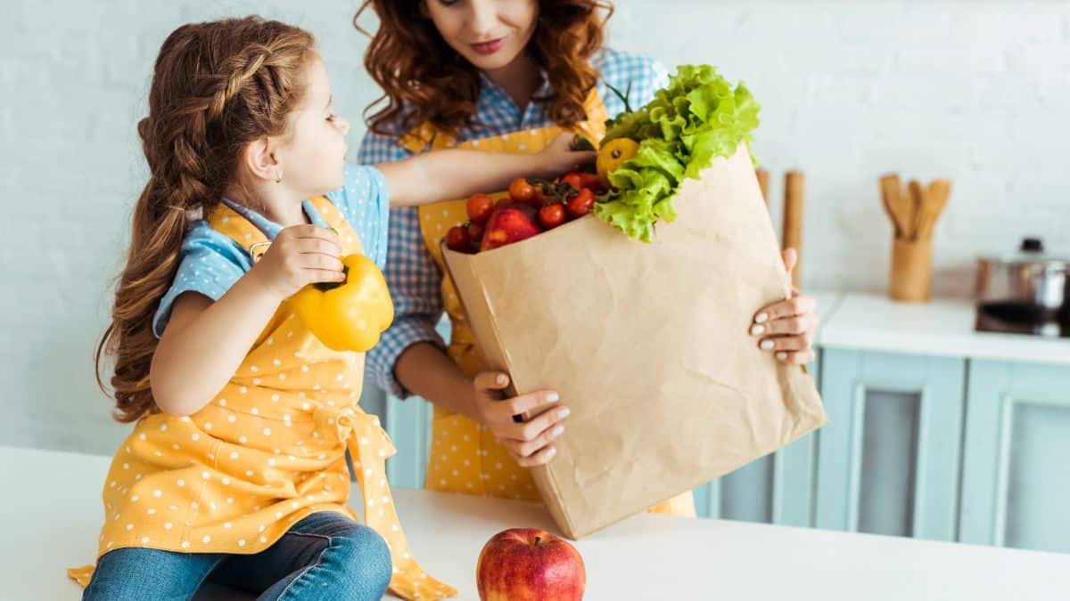 Food Catchphrases mother and daughter in kitchen with vegetables