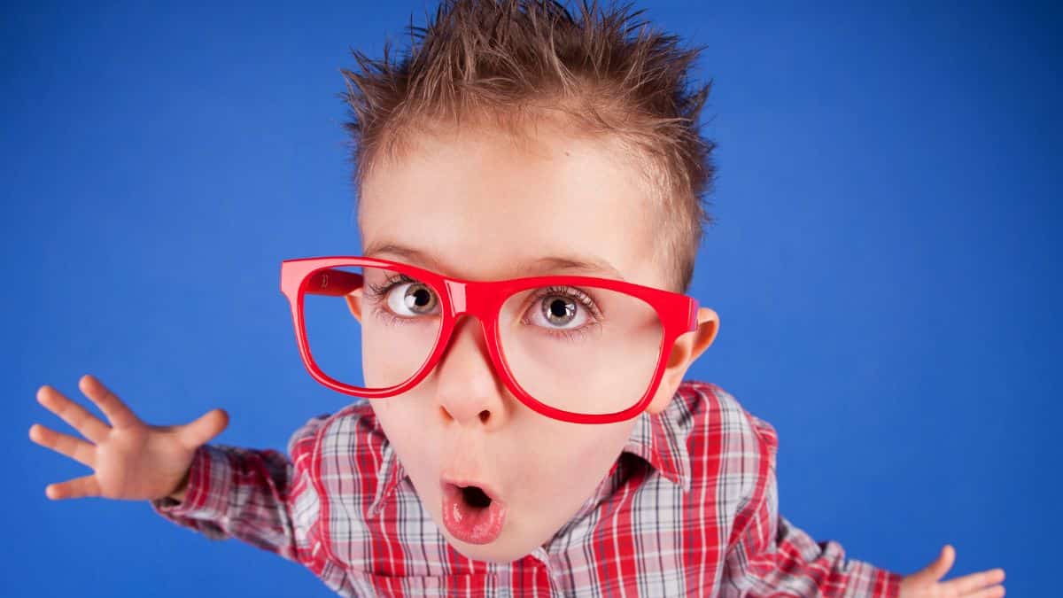 Young Boy with big red glasses looking shocked