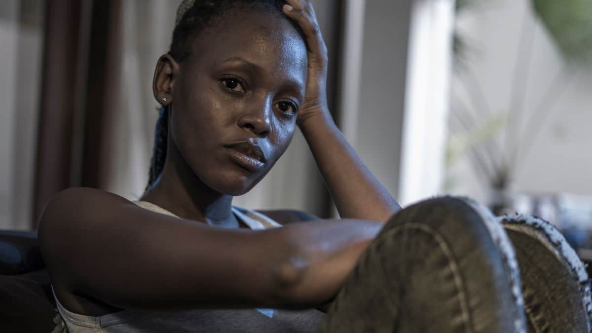 woman sitting down looking stressed