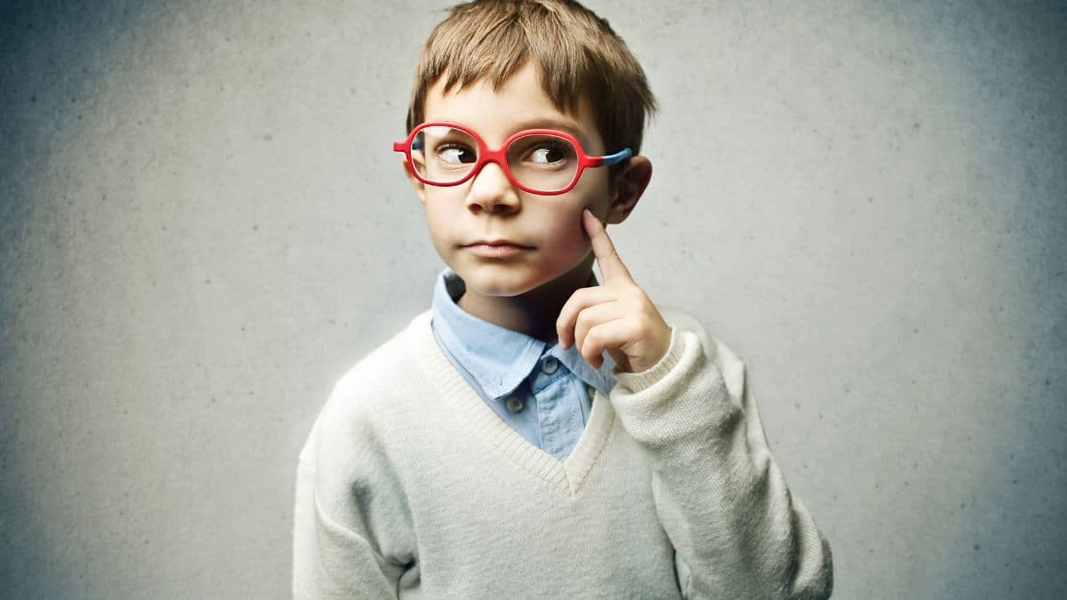 boy thinking with red glasses finger on cheek