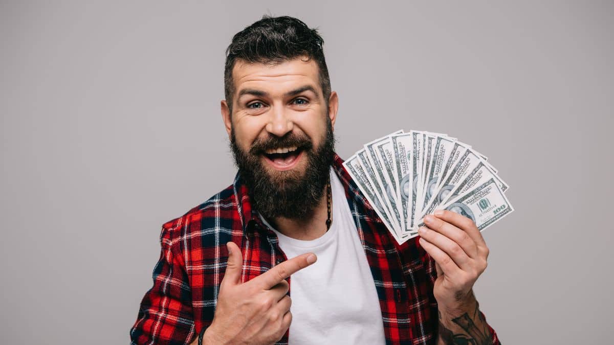 man smiling with money