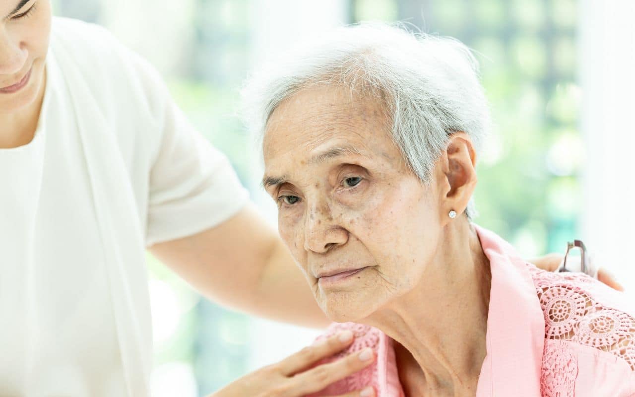 elderly woman looking sad